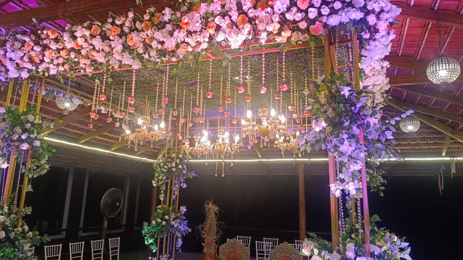 Floral mandap with pink roses and chandeliers